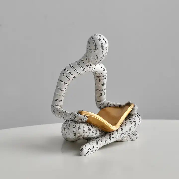 Man reading book sculpture